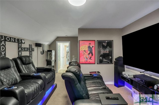 home theater room featuring vaulted ceiling and carpet floors