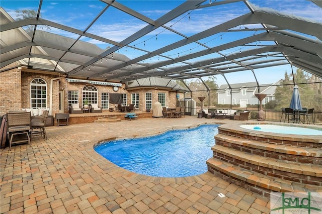 view of pool with glass enclosure, a jacuzzi, outdoor lounge area, and a patio