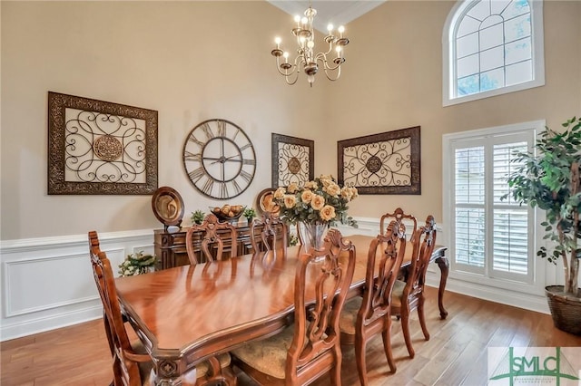 dining room with an inviting chandelier and wood-type flooring