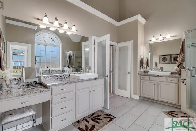 bathroom with vanity, tile patterned floors, and a shower with door