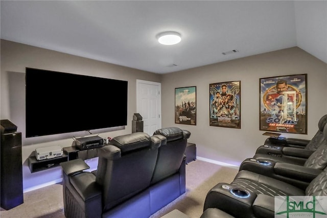 carpeted cinema room with vaulted ceiling