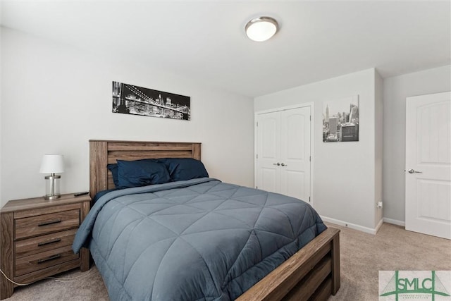 bedroom featuring light colored carpet and a closet