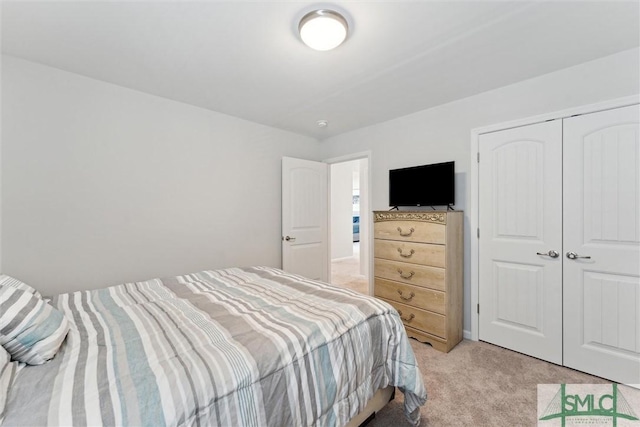 bedroom with light colored carpet and a closet