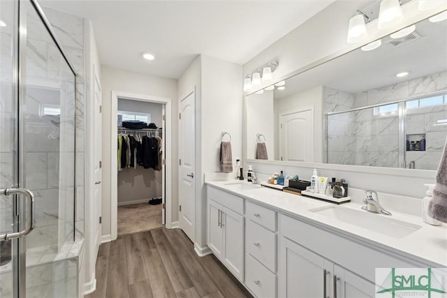 bathroom with an enclosed shower and vanity