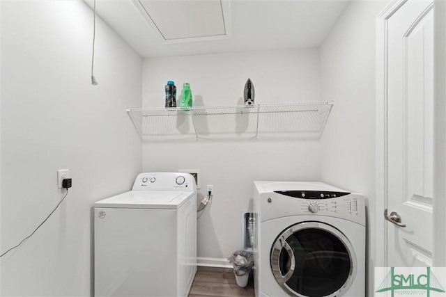 washroom featuring washer and clothes dryer and hardwood / wood-style flooring