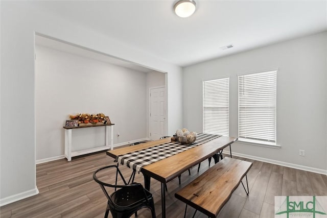 dining area with hardwood / wood-style floors