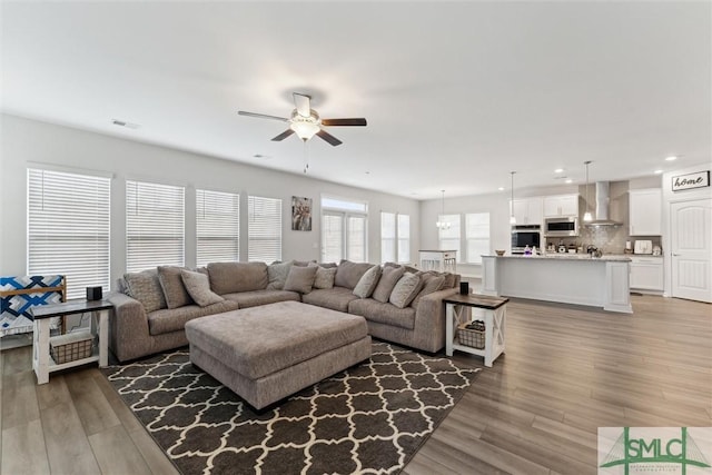 living room with ceiling fan and hardwood / wood-style flooring