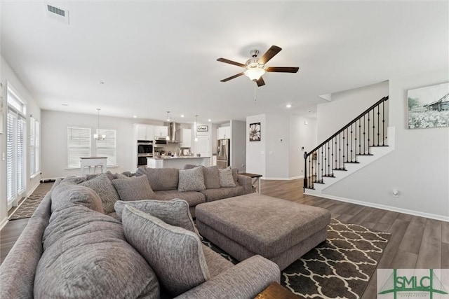 living room with ceiling fan and dark wood-type flooring