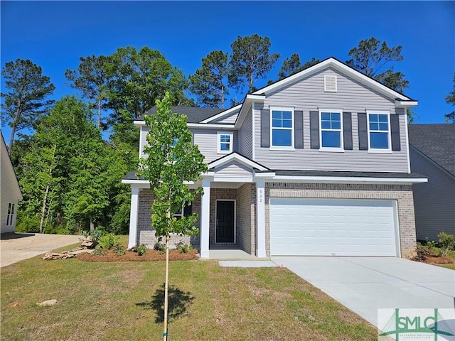 traditional-style home with concrete driveway, brick siding, a front yard, and a garage
