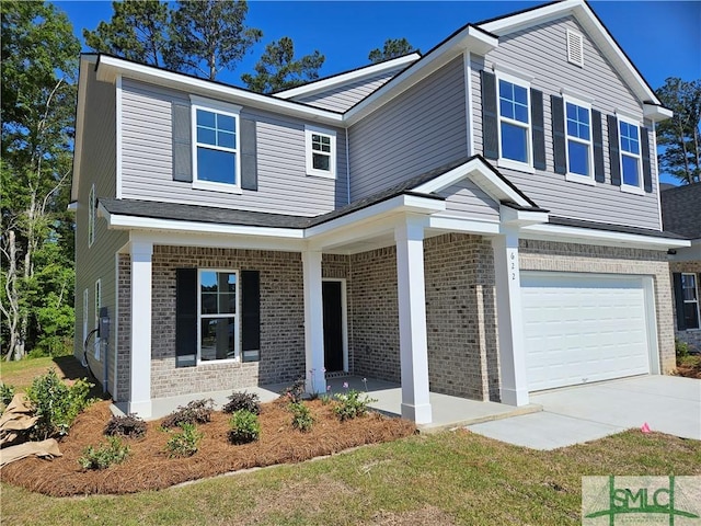 traditional-style home featuring covered porch, an attached garage, concrete driveway, and brick siding