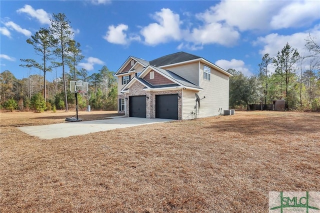 view of home's exterior featuring a garage and central AC unit