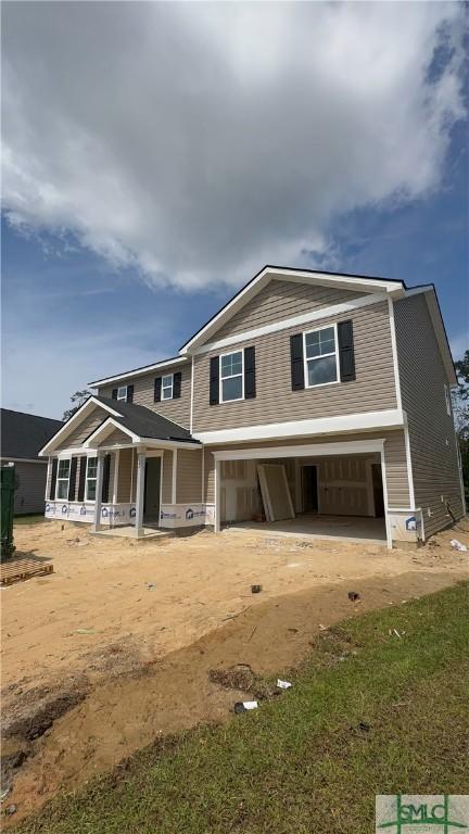 craftsman-style home featuring a porch, driveway, and an attached garage