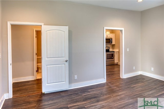 unfurnished room featuring dark wood-type flooring