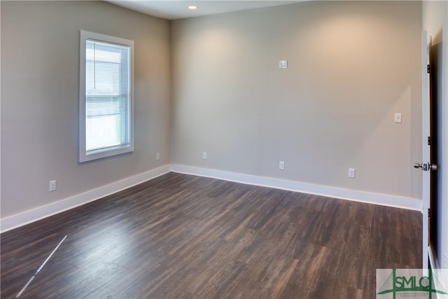 unfurnished room featuring dark wood-type flooring