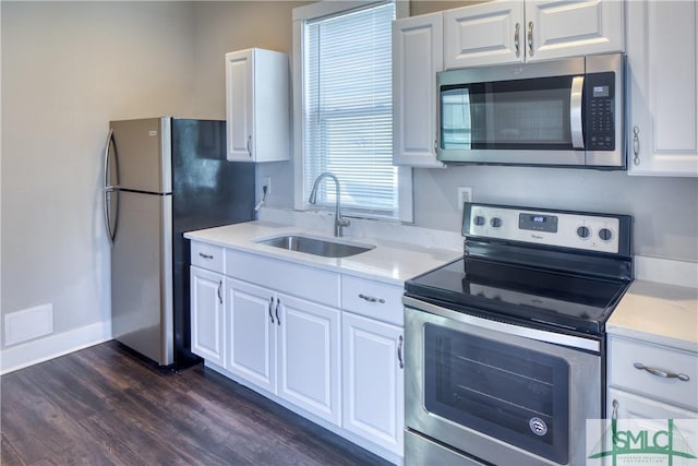 kitchen with dark wood-type flooring, sink, white cabinets, and appliances with stainless steel finishes