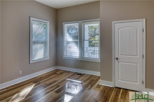 unfurnished room featuring hardwood / wood-style flooring