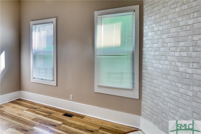 unfurnished room with wood-type flooring