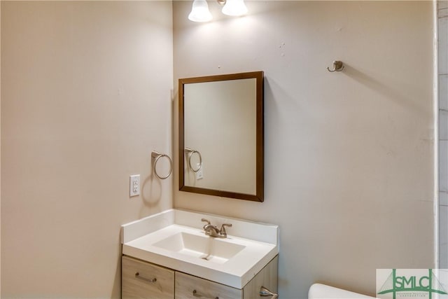 bathroom with toilet and vanity