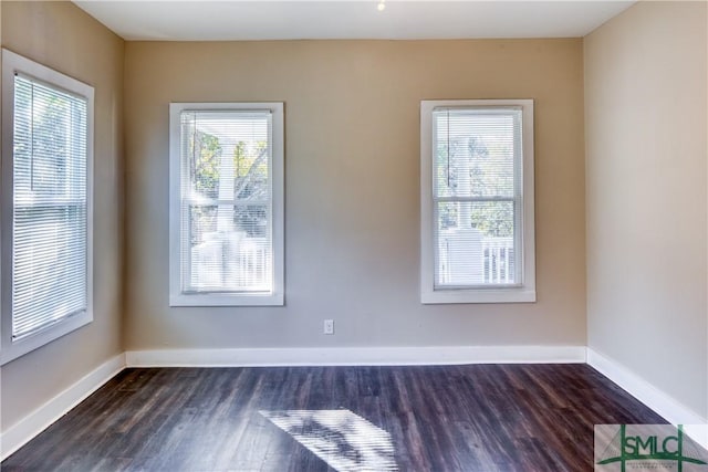 empty room with dark hardwood / wood-style floors