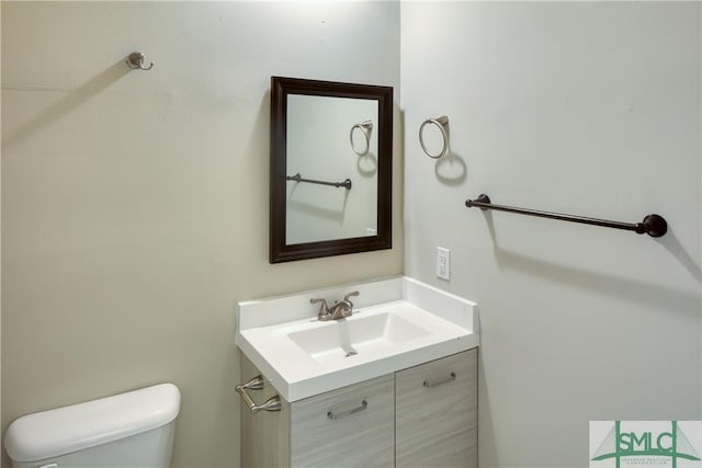 bathroom with toilet and vanity