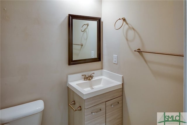 bathroom featuring toilet and vanity