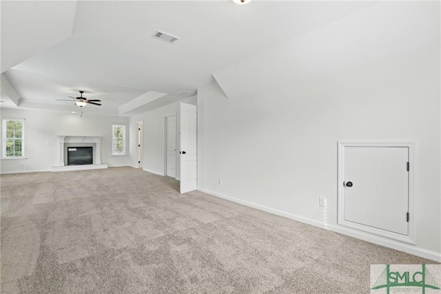 106 Liam Ct, Guyton, GA 31312 - unfurnished living room featuring ceiling fan, carpet, a raised ceiling, and healthy amount of natural light