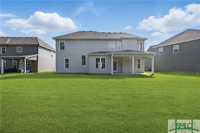 106 Liam Ct, Guyton, GA 31312 - rear view of house with a lawn and a patio