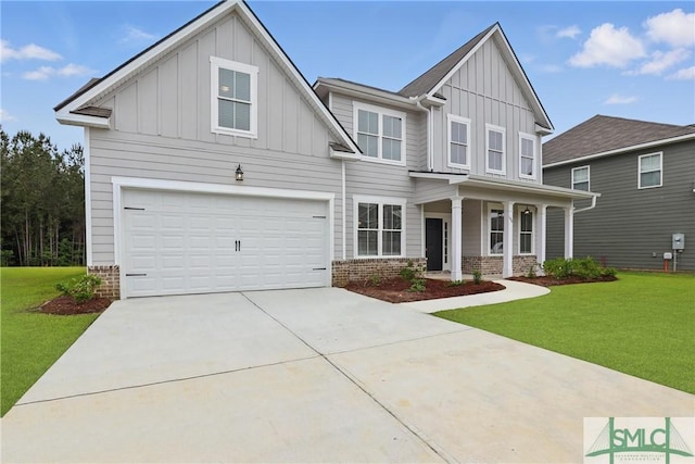106 Liam Ct, Guyton, GA 31312 - view of front of home with board and batten siding, a front yard, a porch, and driveway