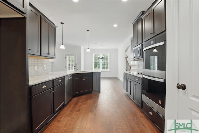 106 Liam Ct, Guyton, GA 31312 - kitchen featuring appliances with stainless steel finishes, a peninsula, tasteful backsplash, a sink, and recessed lighting
