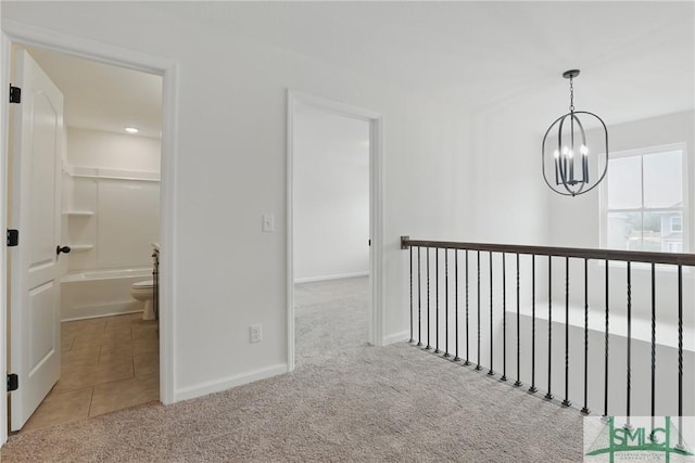 106 Liam Ct, Guyton, GA 31312 - hallway with carpet floors, a chandelier, baseboards, and tile patterned flooring