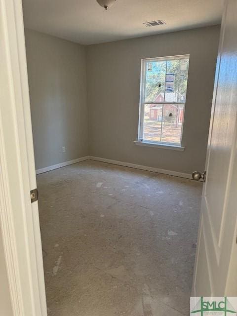 spare room featuring baseboards and visible vents