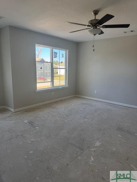 unfurnished room with visible vents, baseboards, and a ceiling fan