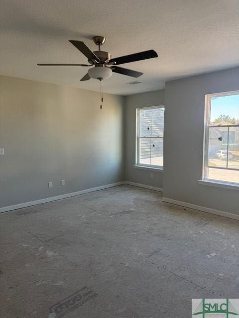 unfurnished room with baseboards