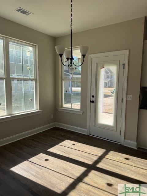 interior space with dark hardwood / wood-style floors and a notable chandelier