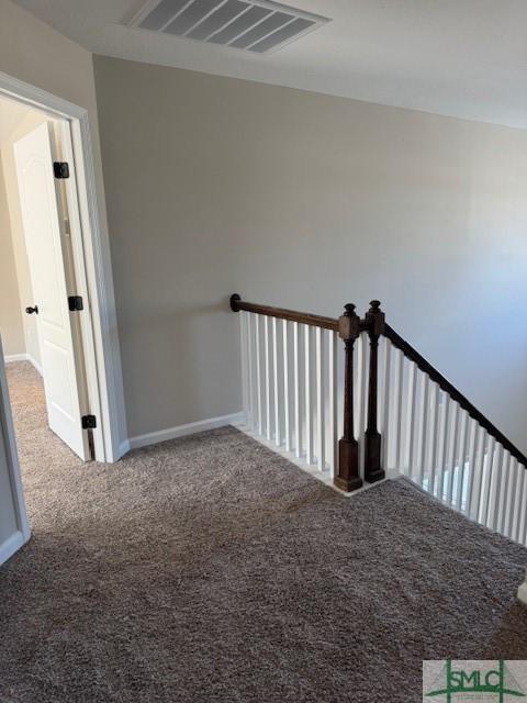 staircase featuring carpet