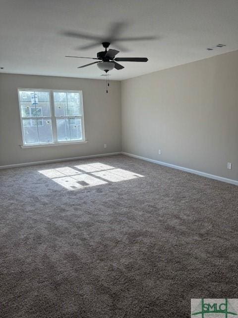 carpeted spare room with ceiling fan