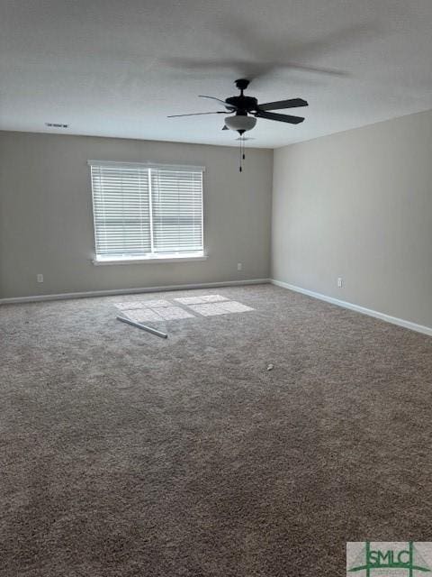 empty room featuring ceiling fan, baseboards, and carpet flooring