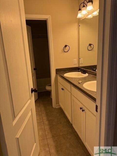 full bath featuring tile patterned flooring, a sink, toilet, and double vanity