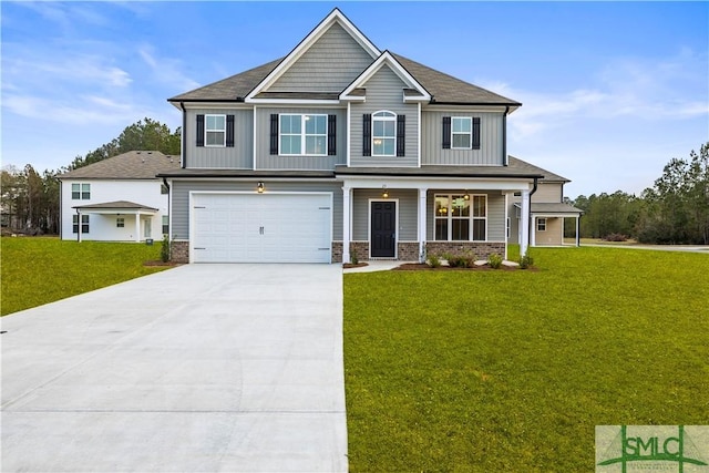 craftsman inspired home featuring a porch, an attached garage, concrete driveway, and a front yard