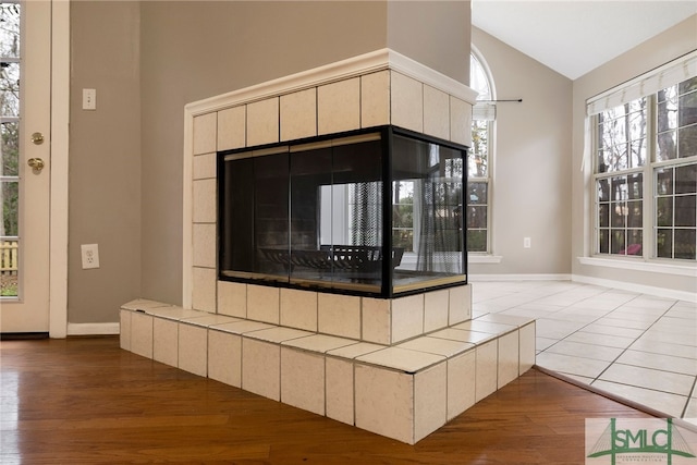 room details featuring wood-type flooring and a tile fireplace