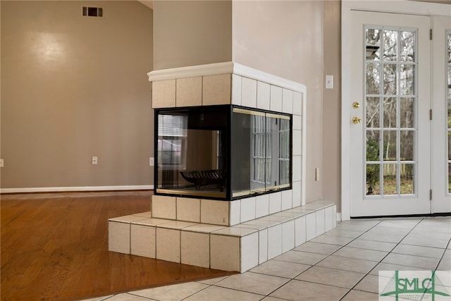 unfurnished living room with light tile patterned flooring