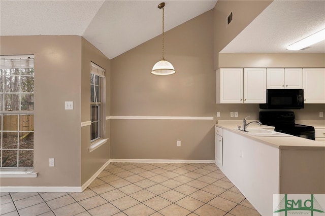 kitchen with vaulted ceiling, black appliances, light tile patterned flooring, hanging light fixtures, and white cabinets