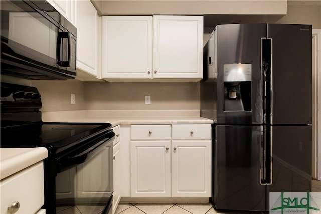 kitchen featuring white cabinetry, light tile patterned floors, and black appliances