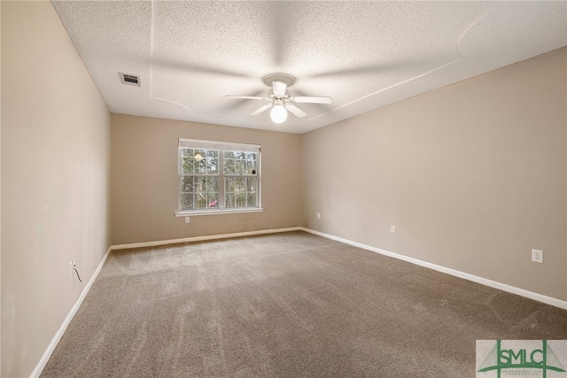 spare room with carpet floors, a textured ceiling, and ceiling fan