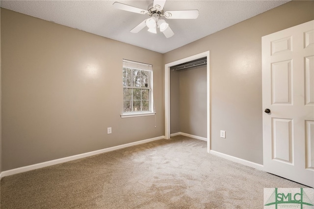 unfurnished bedroom featuring ceiling fan, carpet, a closet, and a textured ceiling