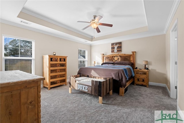 bedroom with ornamental molding, light colored carpet, a raised ceiling, and ceiling fan