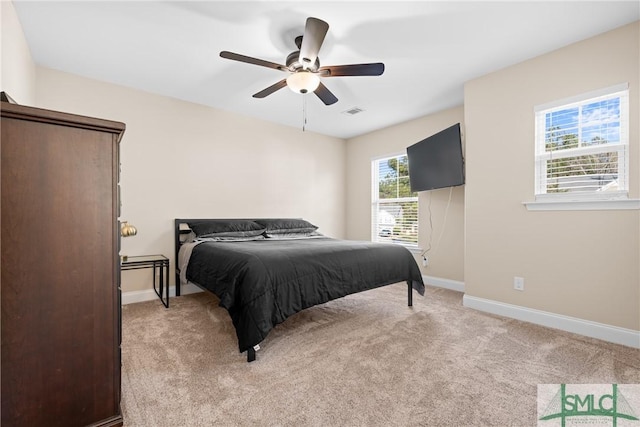 bedroom featuring ceiling fan and light carpet