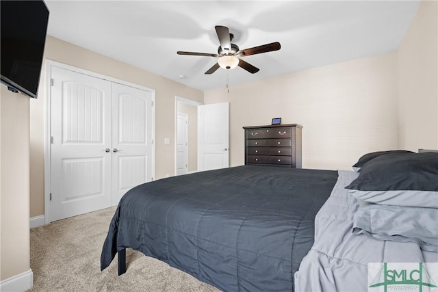 carpeted bedroom with a closet and ceiling fan