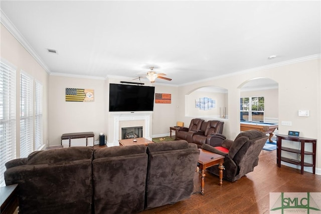 living room featuring hardwood / wood-style flooring, ceiling fan, and ornamental molding