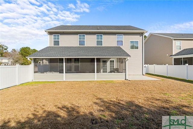 back of property featuring a yard, a patio, and a sunroom